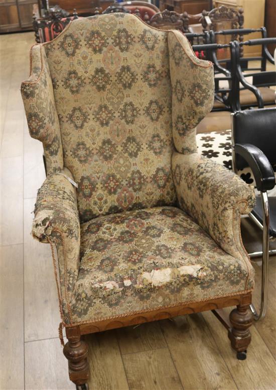 An upholstered wing back armchair